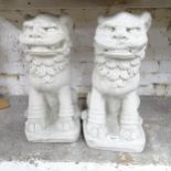 A pair of modern composite garden statues in the form of Dogs of Foo. Height 47cm.