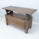 An early 20th century oak monk's bench. Dimensions (closed) 107x68x46cm