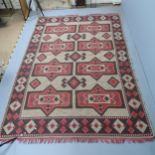 A cream-ground Kilim carpet. 295x205cm.