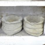 A pair of concrete sack design planters. 45x25cm.