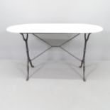 An oval marble-topped garden table on cast iron base. 122x72x60cm.