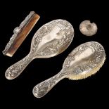 A matching Art Nouveau silver-backed dressing table brush and hand mirror, with embossed decoration,