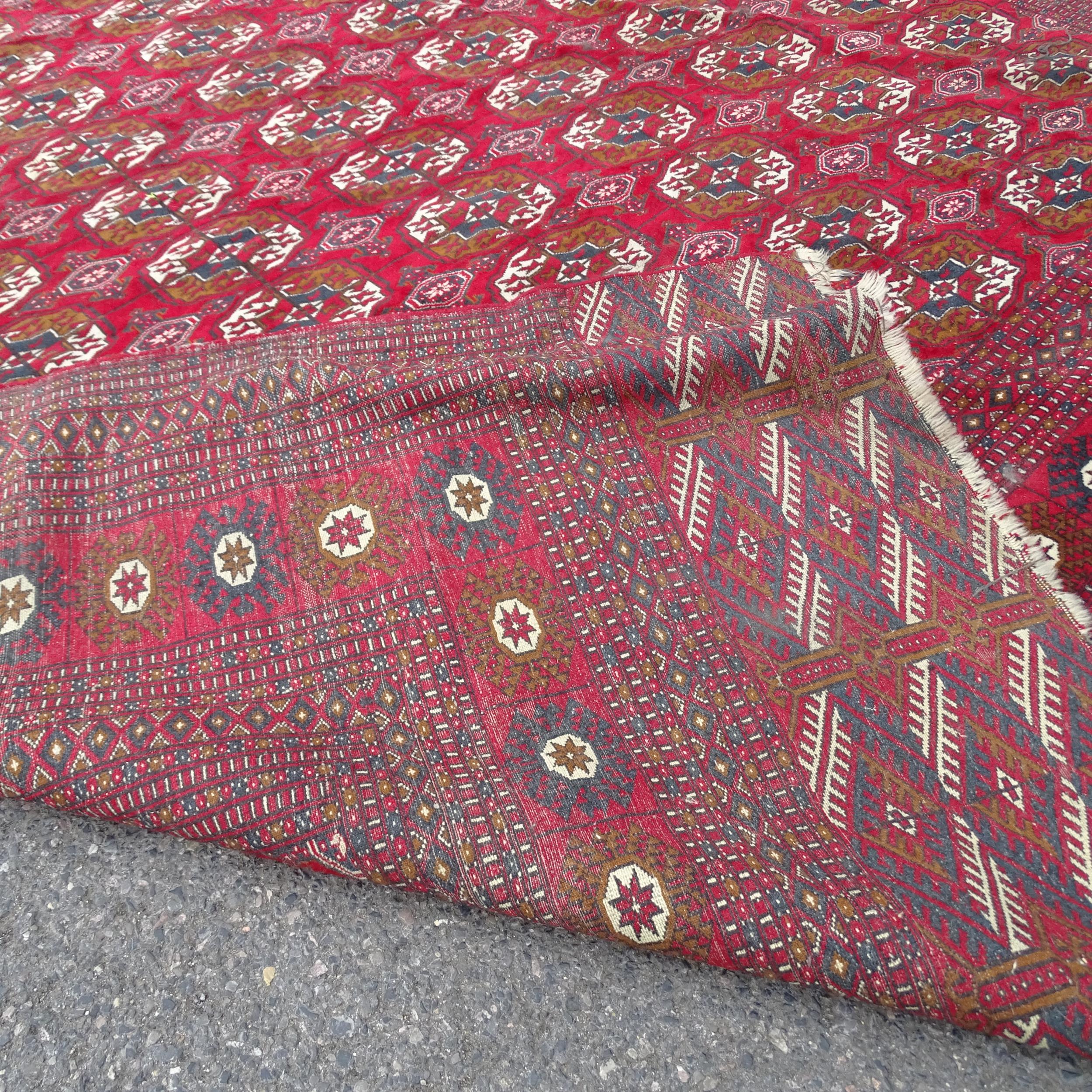 A large red ground Afghan carpet. 378 x 279cm. - Image 2 of 2