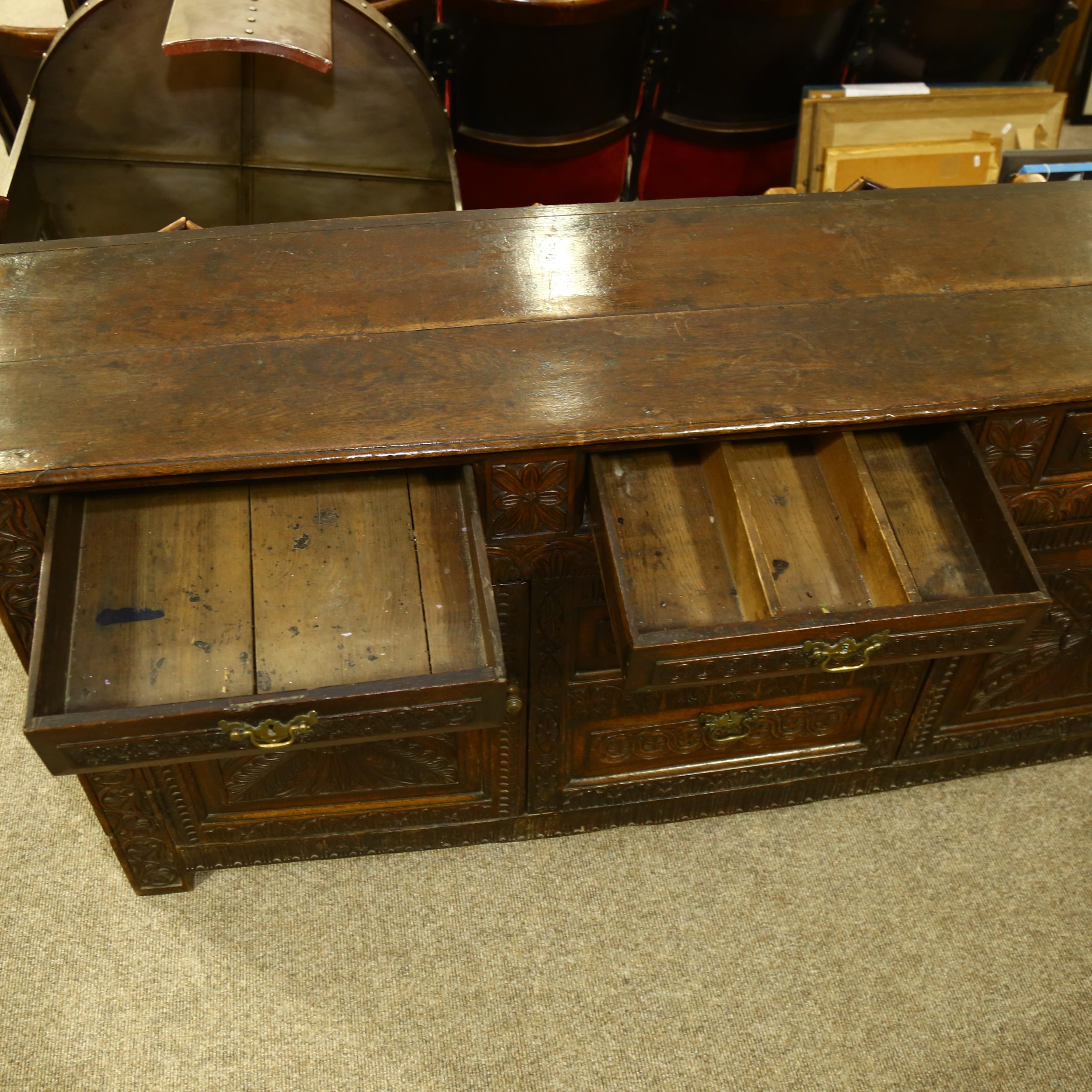 An 18th century oak dresser base, 3 carved frieze drawers with central dummy drawers below flanked - Image 4 of 6