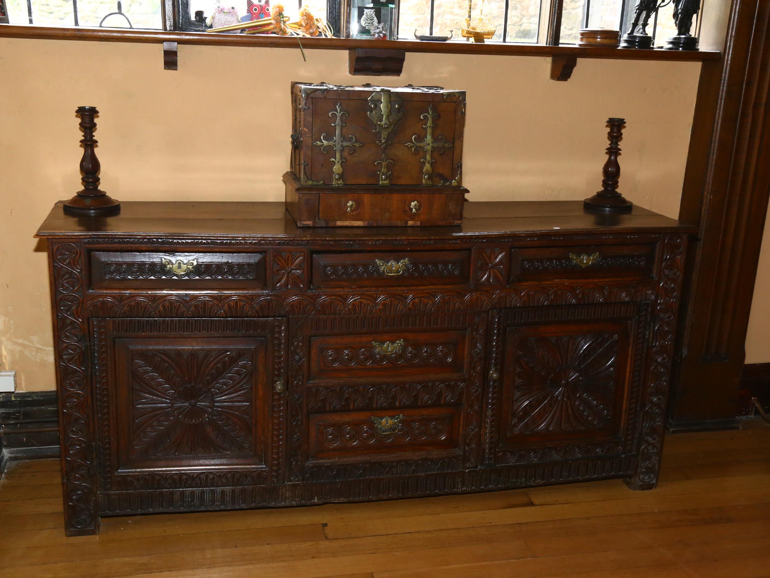 An 18th century oak dresser base, 3 carved frieze drawers with central dummy drawers below flanked