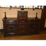 An 18th century oak dresser base, 3 carved frieze drawers with central dummy drawers below flanked