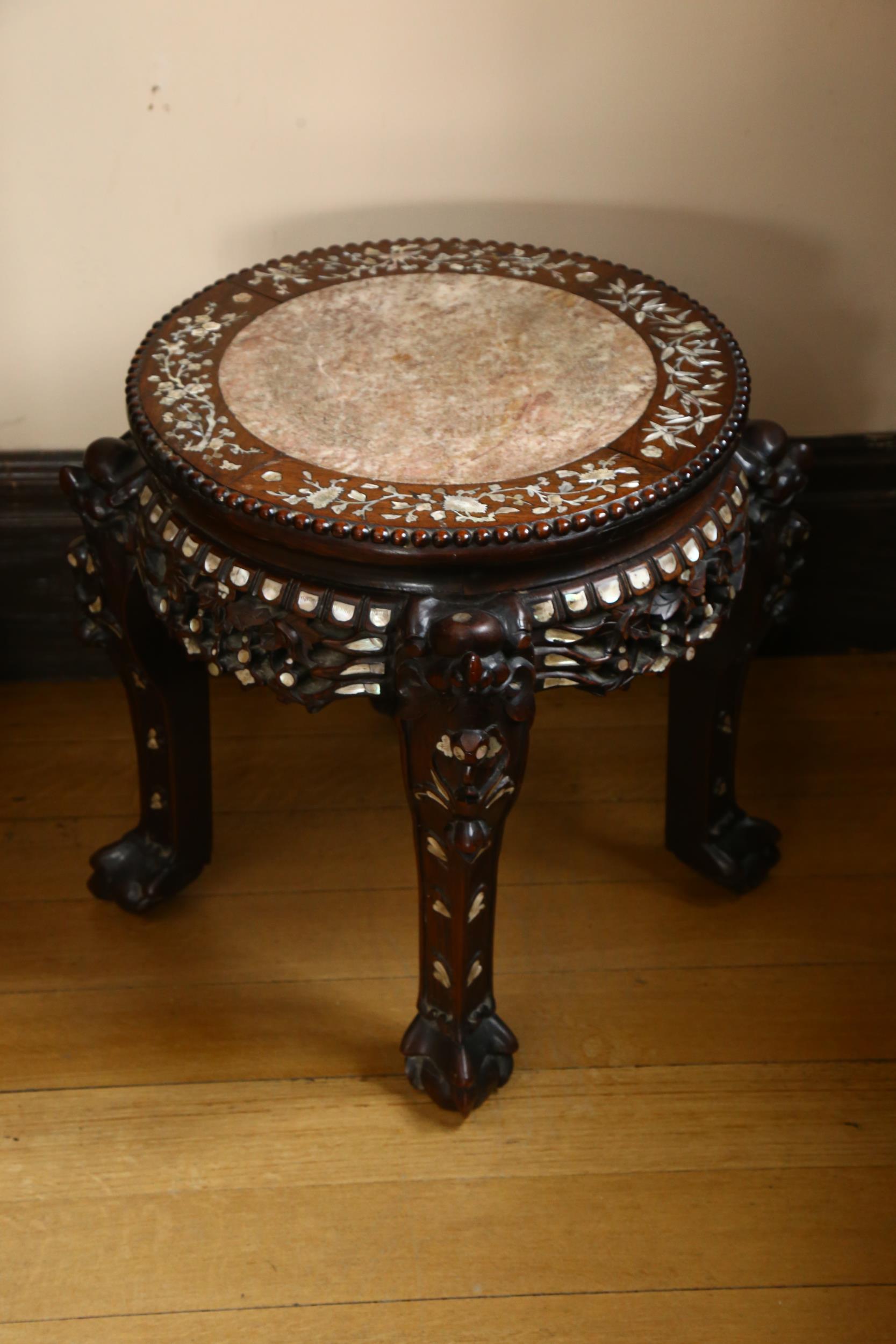 A 19th century Chinese hardwood and mother-of-pearl inlaid circular table, with inset marble top,