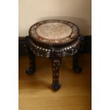 A 19th century Chinese hardwood and mother-of-pearl inlaid circular table, with inset marble top,