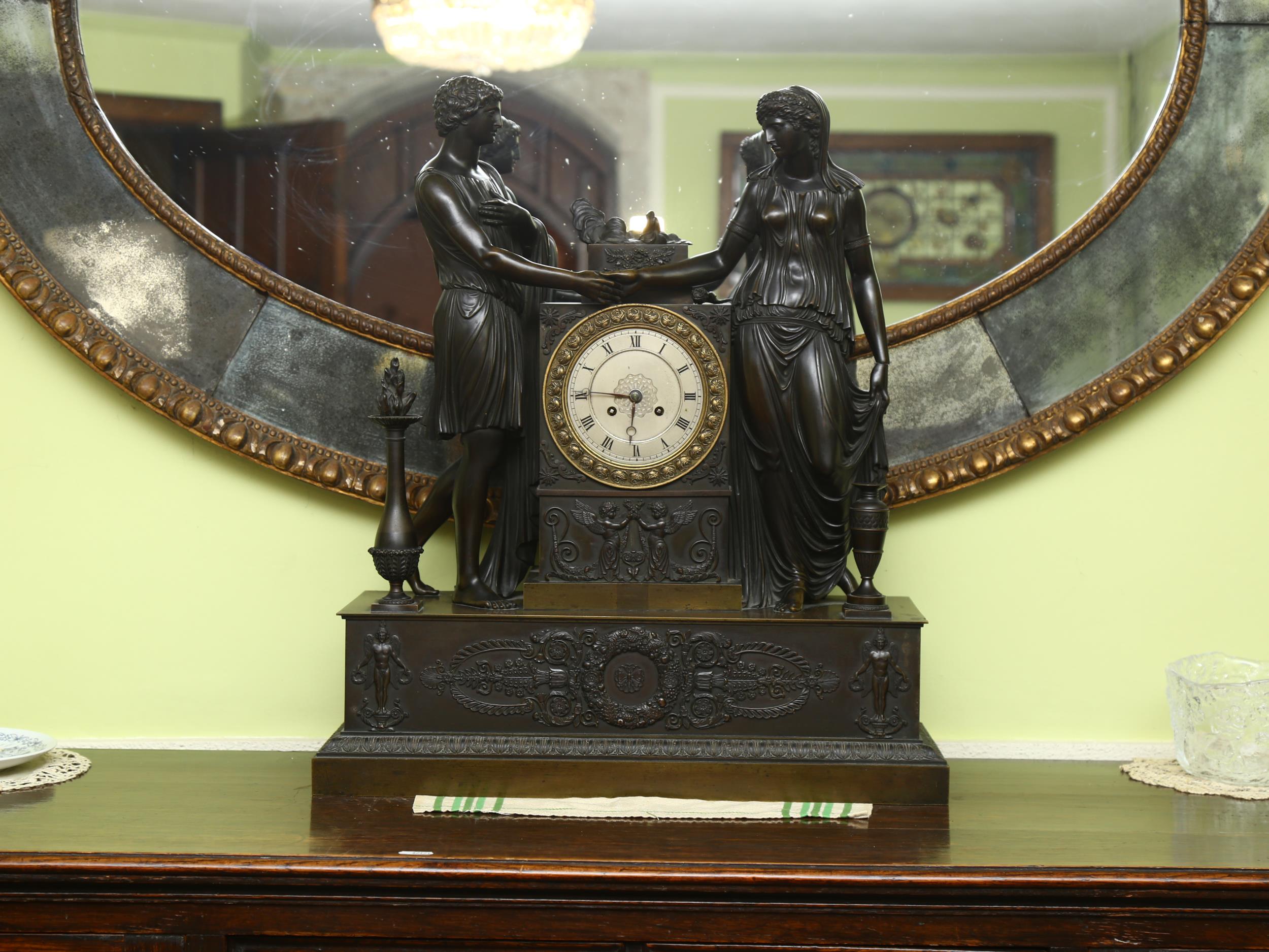 A 19th century French patinated bronze-cased 8-day mantel clock, surmounted by Classical temple