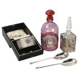 A cased silver napkin ring, a cased pair of silver spoons, and 2 perfume bottles with plated mounts