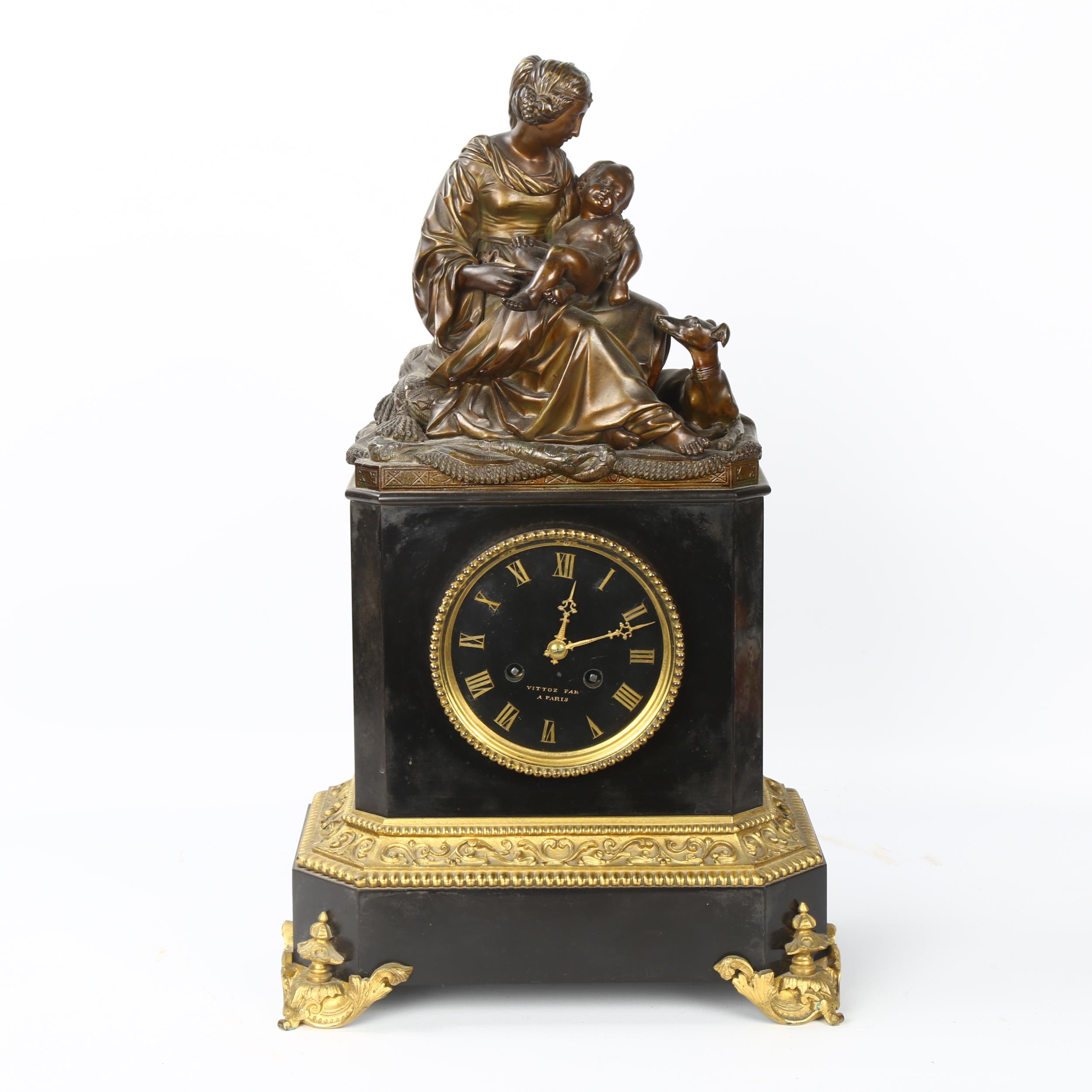 A 19th century ormolu mounted slate-cased mantel clock, surmounted by a gilt-bronze woman and child,