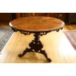 A Regency walnut circular centre table, with central stained floral marquetry inlaid panel, egg