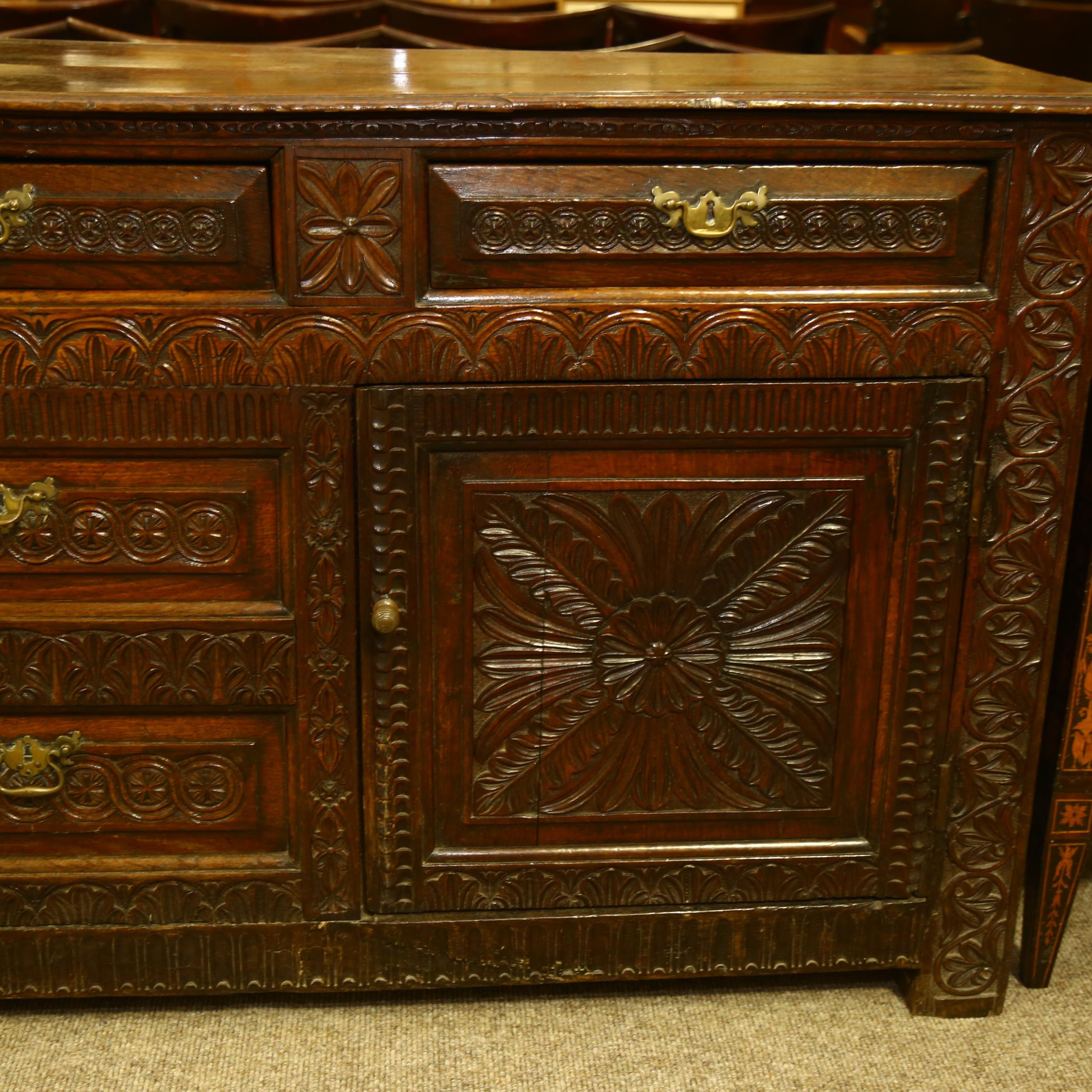 An 18th century oak dresser base, 3 carved frieze drawers with central dummy drawers below flanked - Image 3 of 6