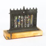 A Gothic Revival patinated bronze stained glass table centre piece, depicting knights standing