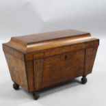 A Regency burr-walnut sarcophagus tea caddy, with ebonised moulding and brass bun feet, width