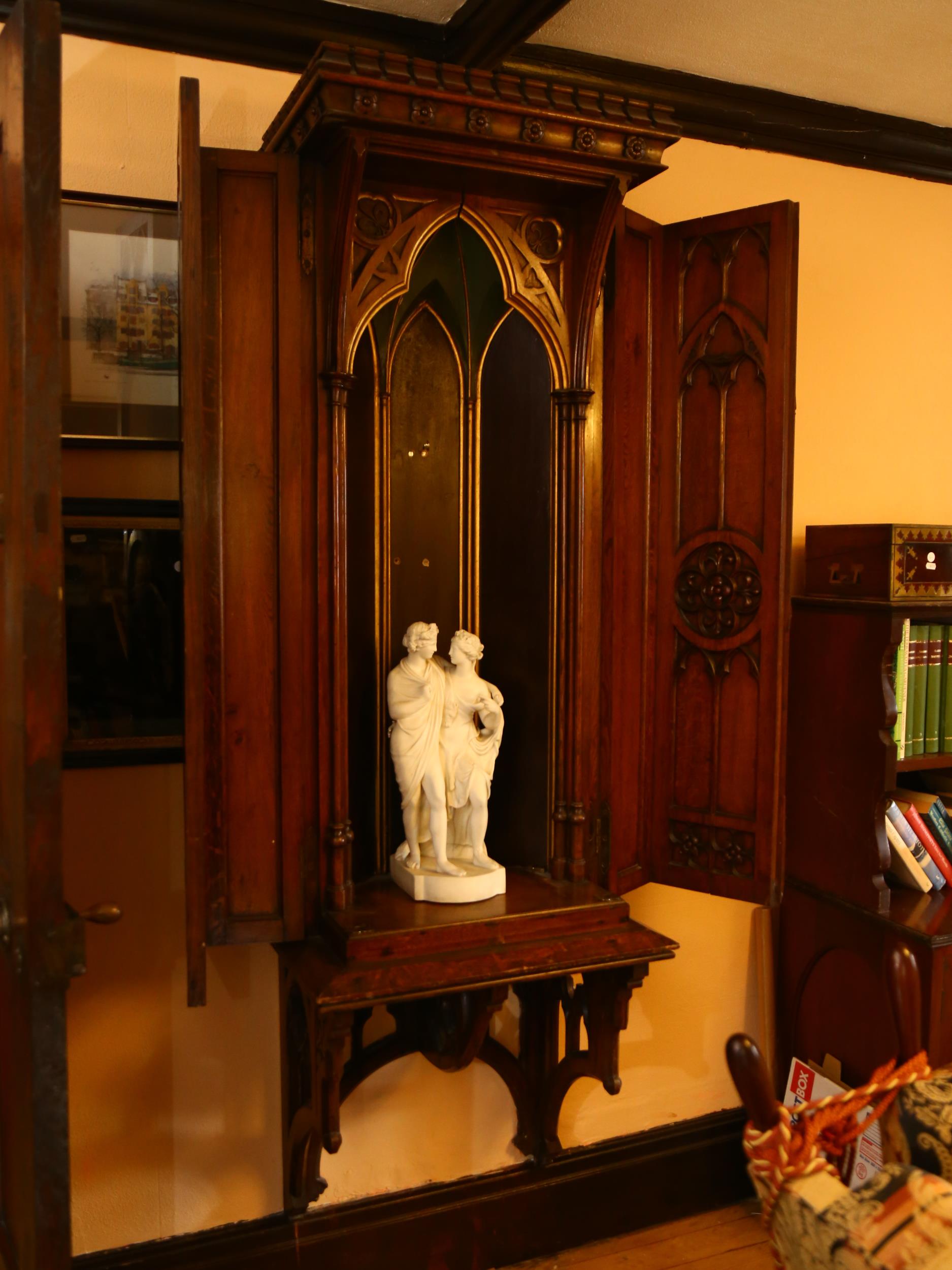 A large 19th century Gothic oak church tabernacle wall-hanging cabinet, the crenellated pediment