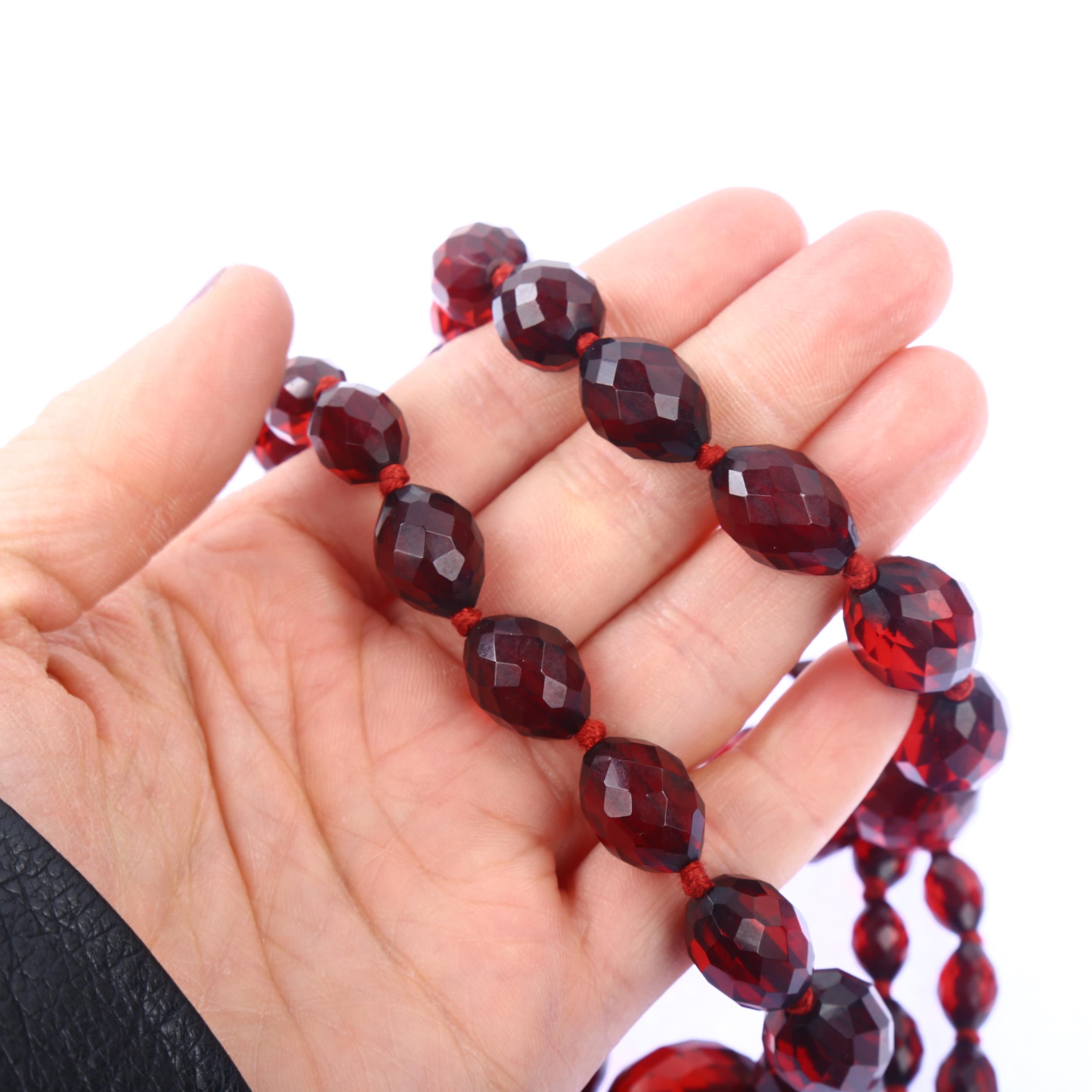 A long graduated single-strand cherry amber bead necklace, beads ranging from 28.1-9.2mm, necklace - Image 4 of 4