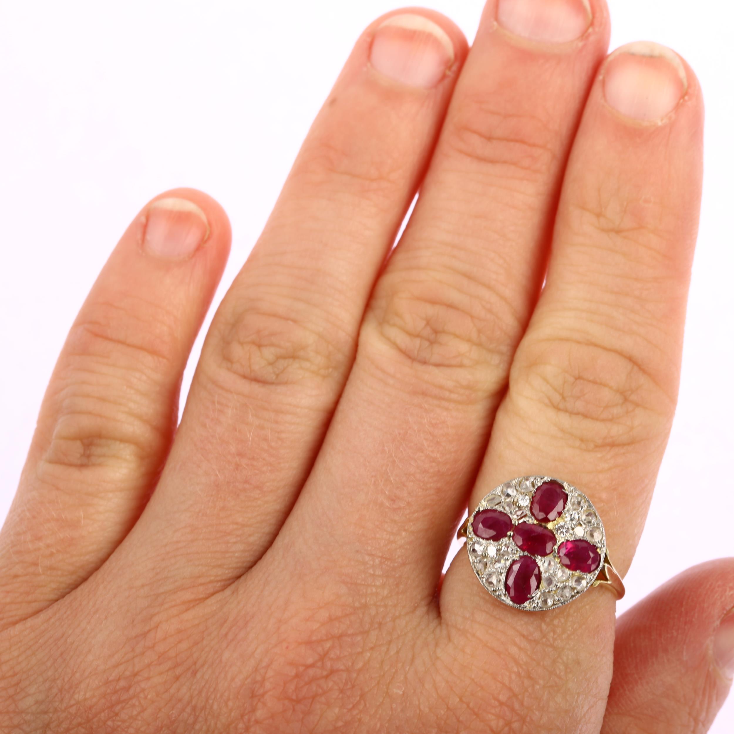 A late 20th century ruby and diamond circular cluster ring, unmarked 18ct gold settings with oval - Image 4 of 4