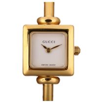 GUCCI - a lady's gold plated stainless steel 1900L quartz bangle watch, white dial with gilt