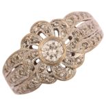 A modern 18ct white gold diamond flowerhead ring, set with modern round brilliant-cut diamonds,