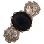 A late 20th century 18ct gold three stone sapphire and diamond ring, prong set with 1.25ct oval