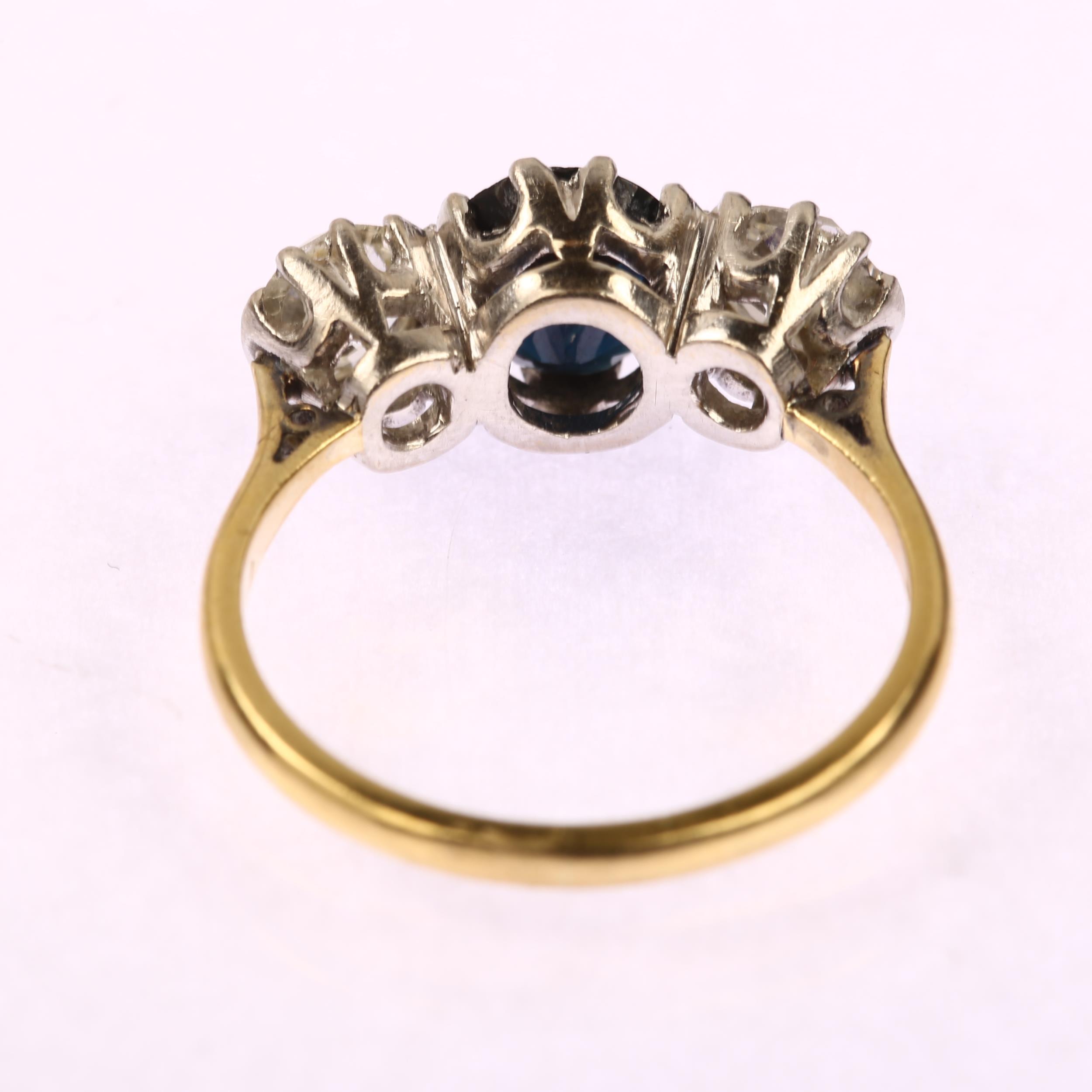 A late 20th century 18ct gold three stone sapphire and diamond ring, prong set with 1.25ct oval - Image 3 of 4