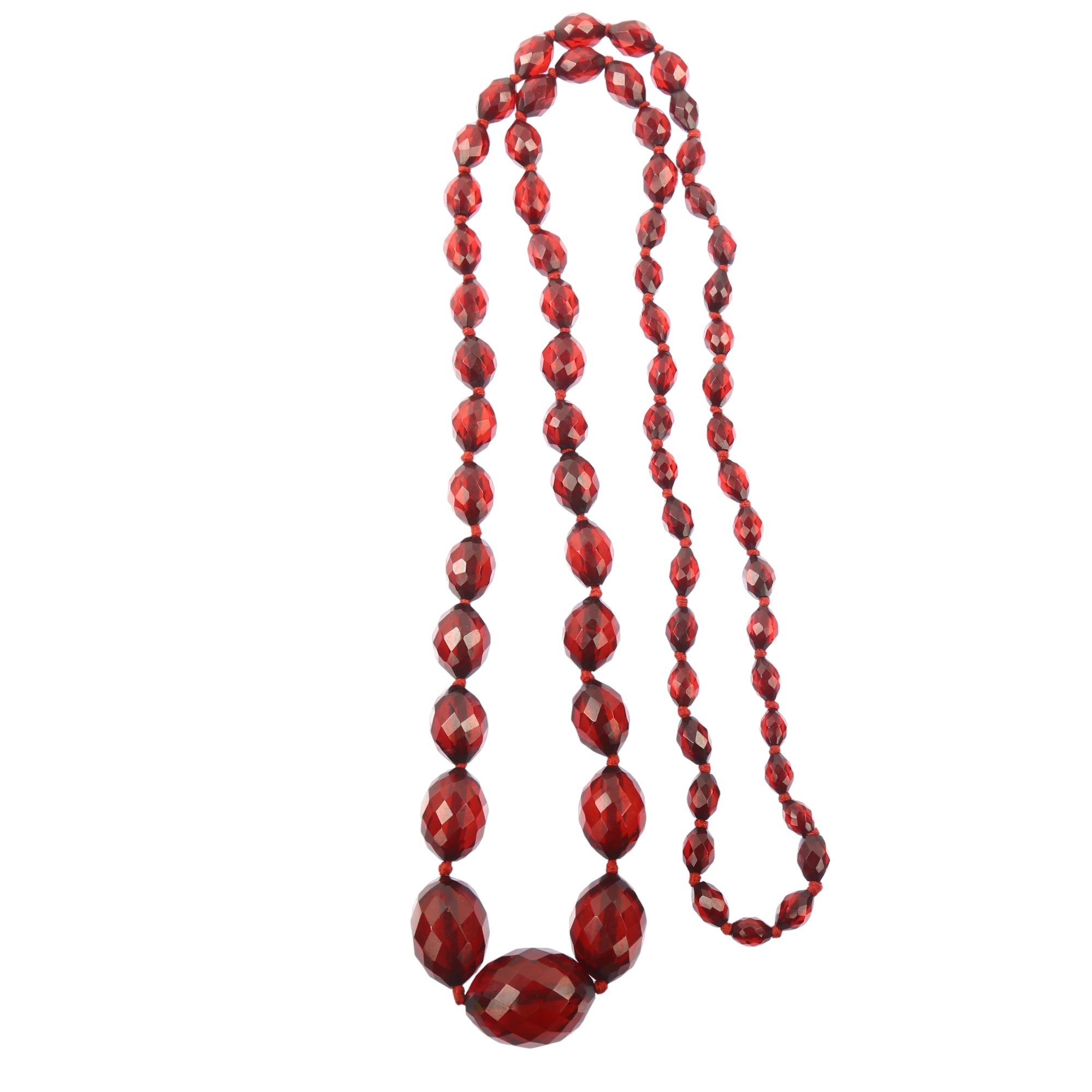 A long graduated single-strand cherry amber bead necklace, beads ranging from 28.1-9.2mm, necklace