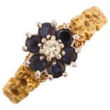 A late 20th century 18ct gold sapphire and diamond cluster flowerhead ring, with textured shoulders,