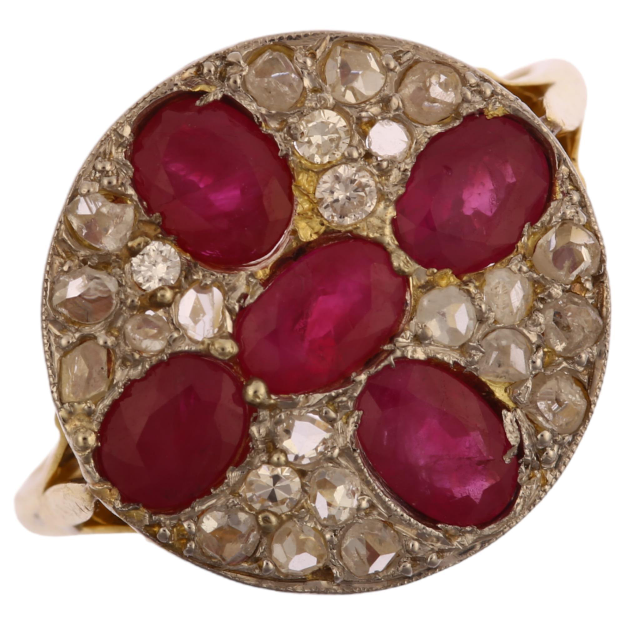 A late 20th century ruby and diamond circular cluster ring, unmarked 18ct gold settings with oval