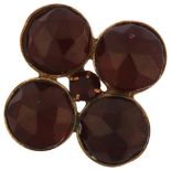 A large Victorian Bohemian garnet quatrefoil ring, unmarked yellow metal closed-back settings,