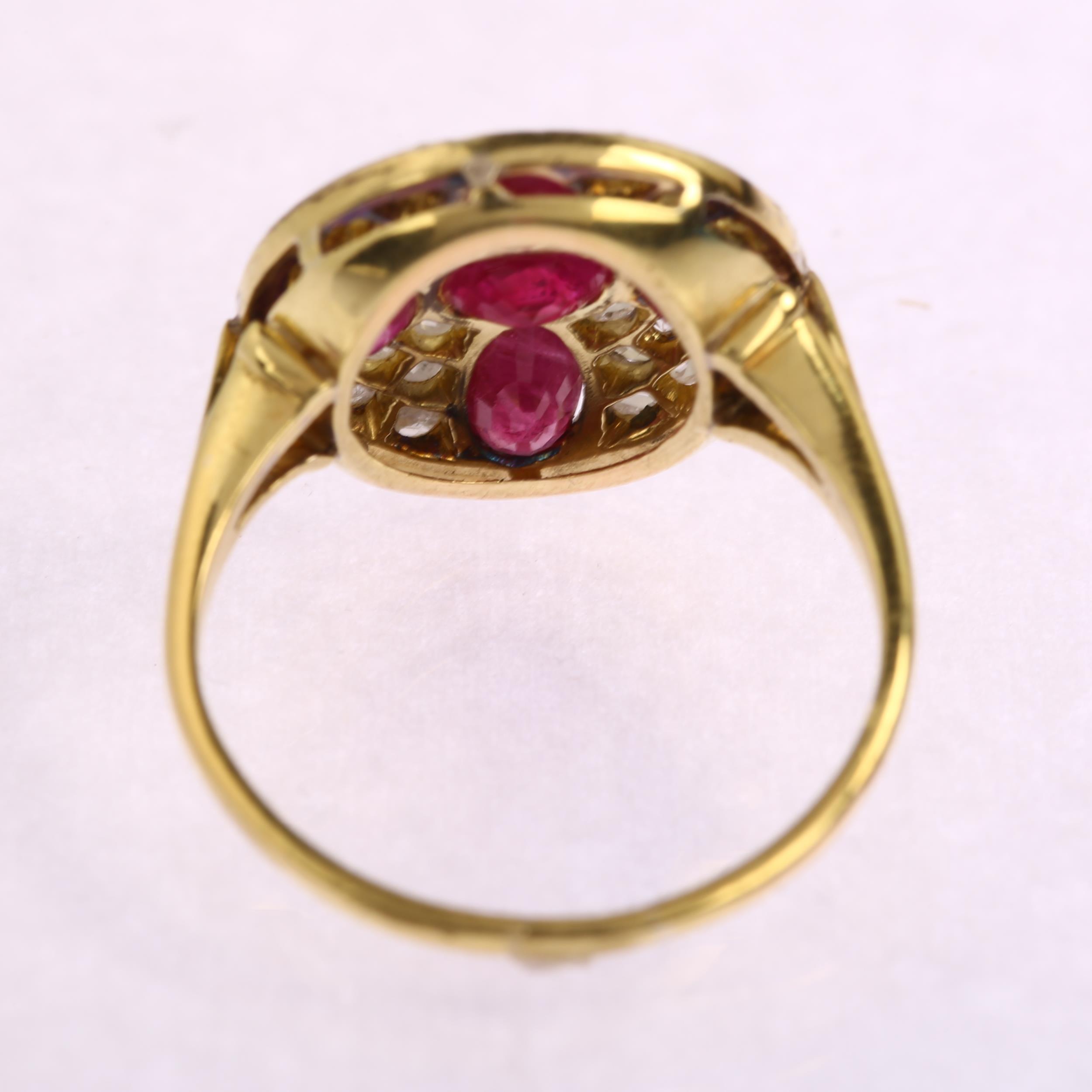 A late 20th century ruby and diamond circular cluster ring, unmarked 18ct gold settings with oval - Image 2 of 4