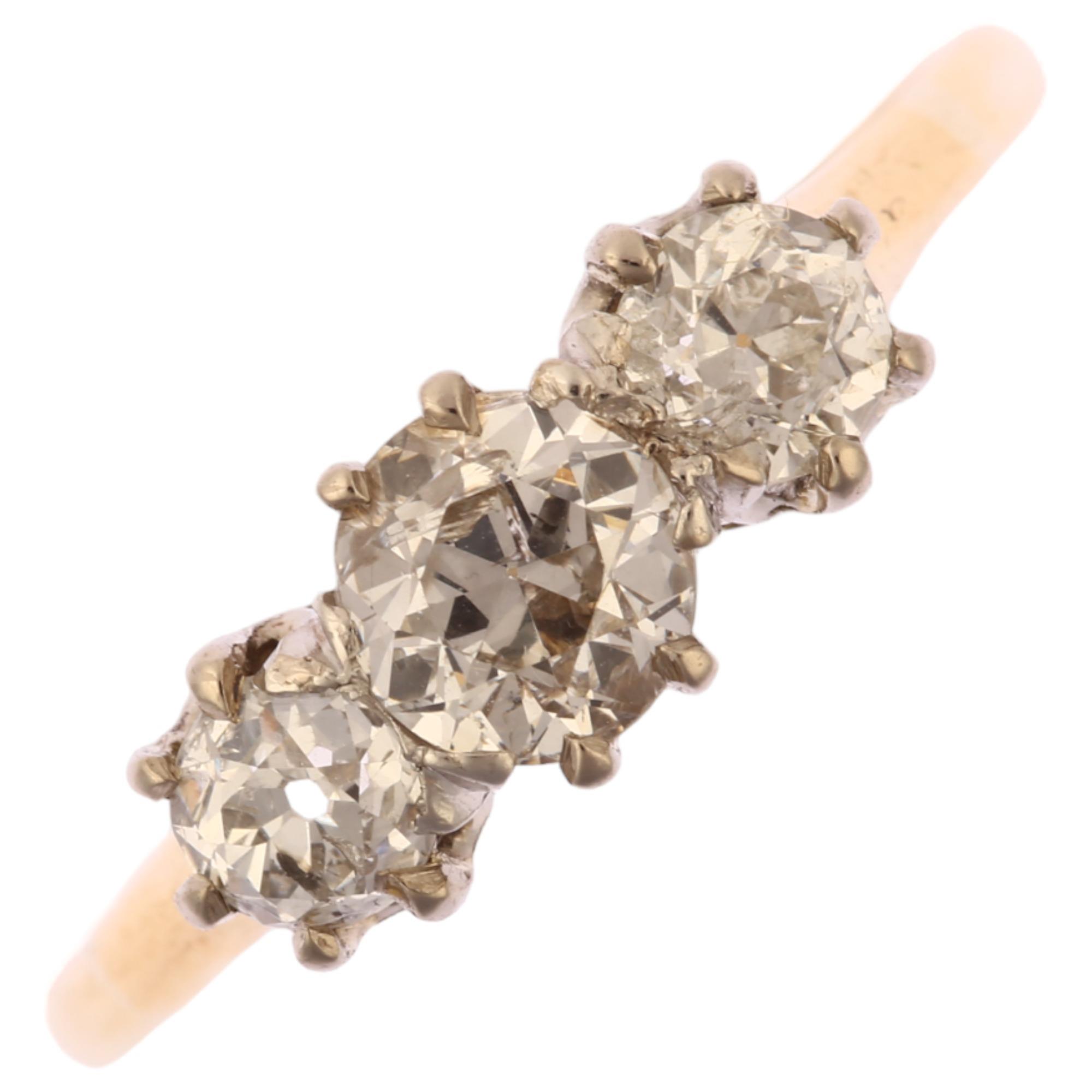 An early 20th century 18ct gold three stone diamond ring, set with old European-cut diamonds,