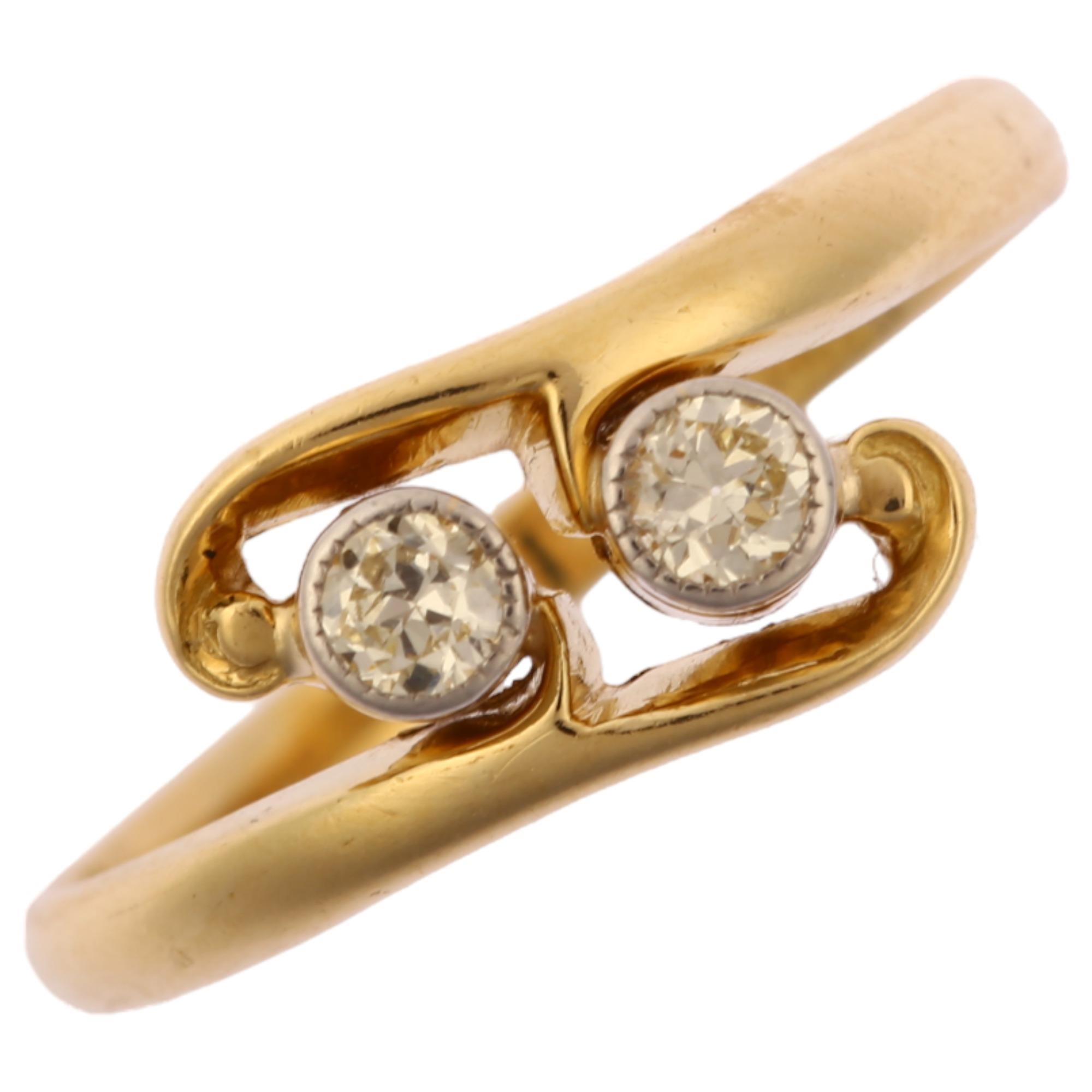 An early 20th century 18ct gold two stone diamond crossover ring, platinum-topped set with modern