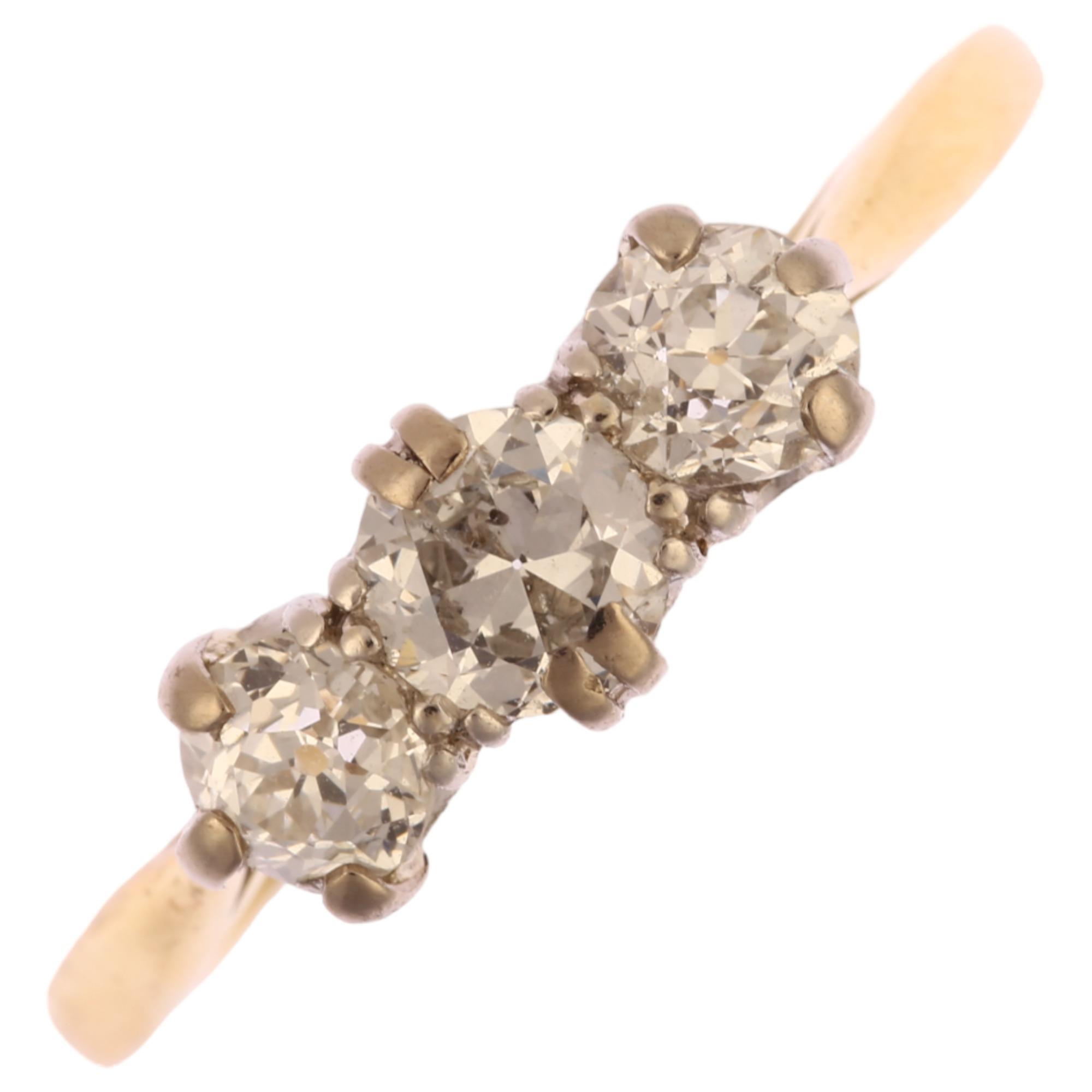 An early 20th century 18ct gold three stone diamond ring, claw set with old-cut diamonds, total