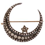 A large Victorian diamond star and crescent moon brooch, circa 1880, the crescent formed of a