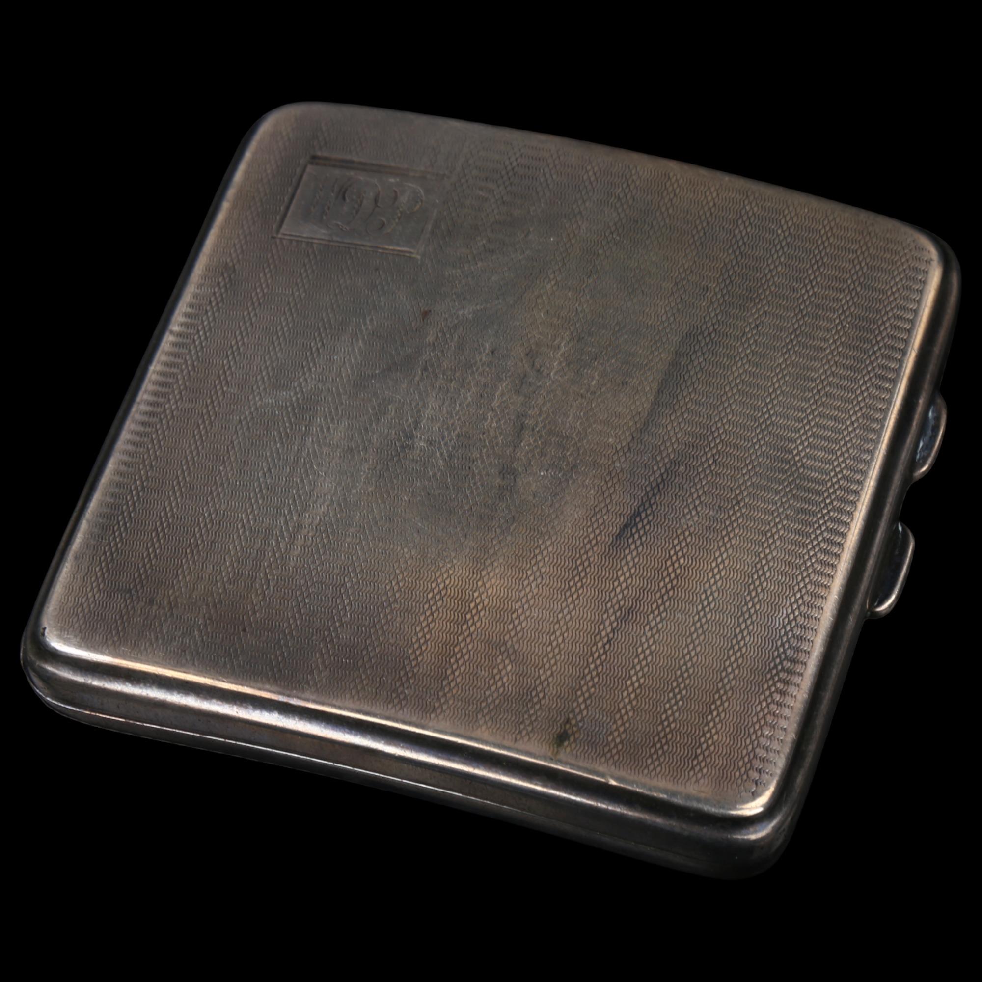 An Art Deco George V curved silver cigarette case, allover engine turned decoration with gilt