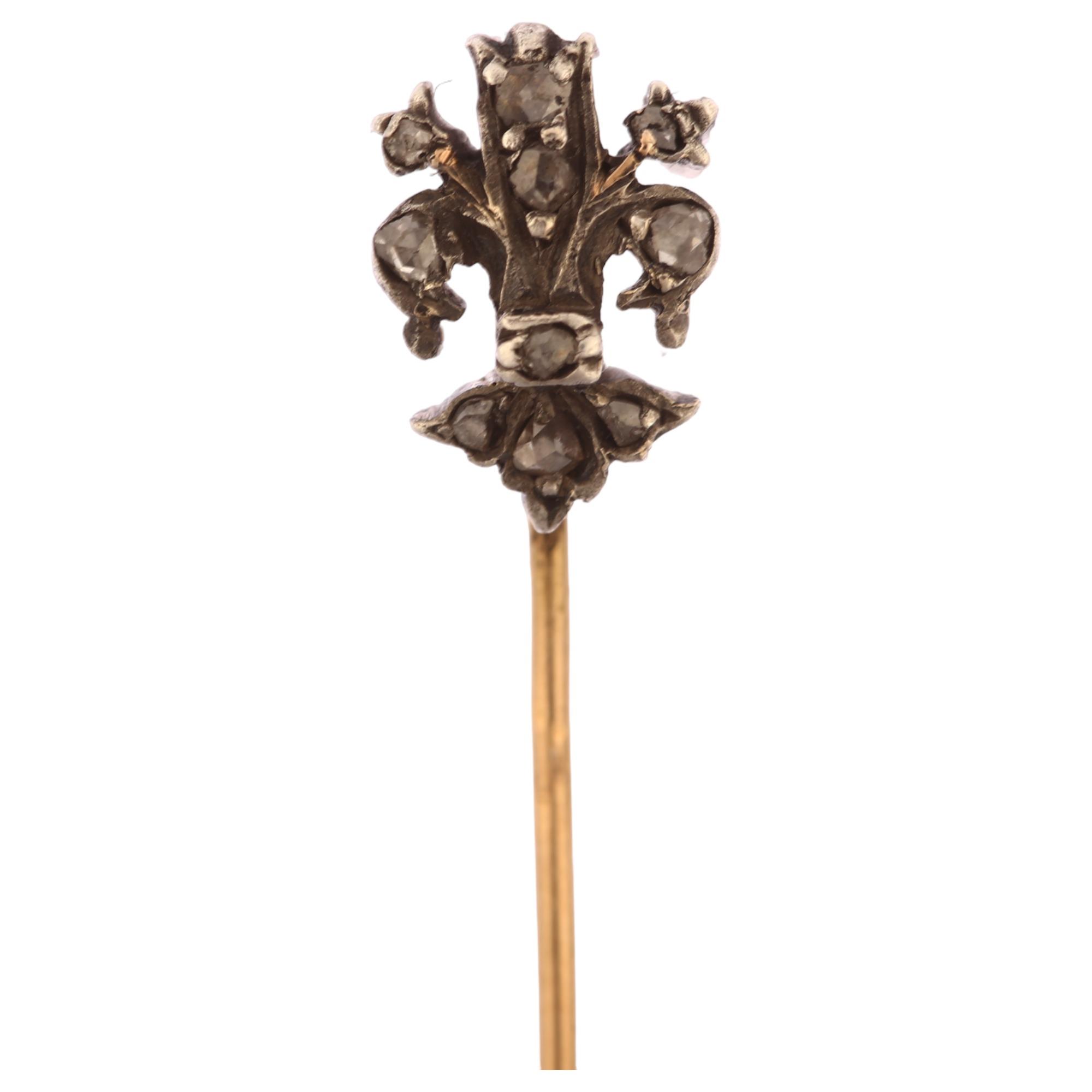 A 19th century diamond fleur-de-lis stickpin, unmarked gold and silver settings with rose-cut