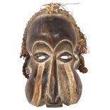 A carved African mask, with rope twist and basketweave decoration, L33cm