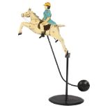 An early 20th century painted balance polo player, metal and lead, the rider having articulated