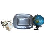 A Mexican aluminium serving dish, 52cm, an illuminated globe, and a Vintage alarm clock table light