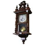 A walnut cased 8-day wall clock. Height 90cm. Movement appears over-wound so not full working