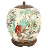 An Antique Chinese jar with enamelled figures and foliage, on carved wood stand, with cover (jar A/