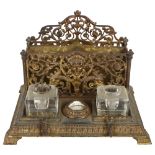 An Antique gilt-brass desk stand, with fitted letter rack and 2 inkwells (inkwells not original),