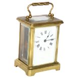 A French brass-cased carriage clock, white enamel dial with Roman numeral hour markers, case