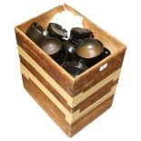 A Japanese pine box containing a large quantity of black lacquer food bowls and saucers