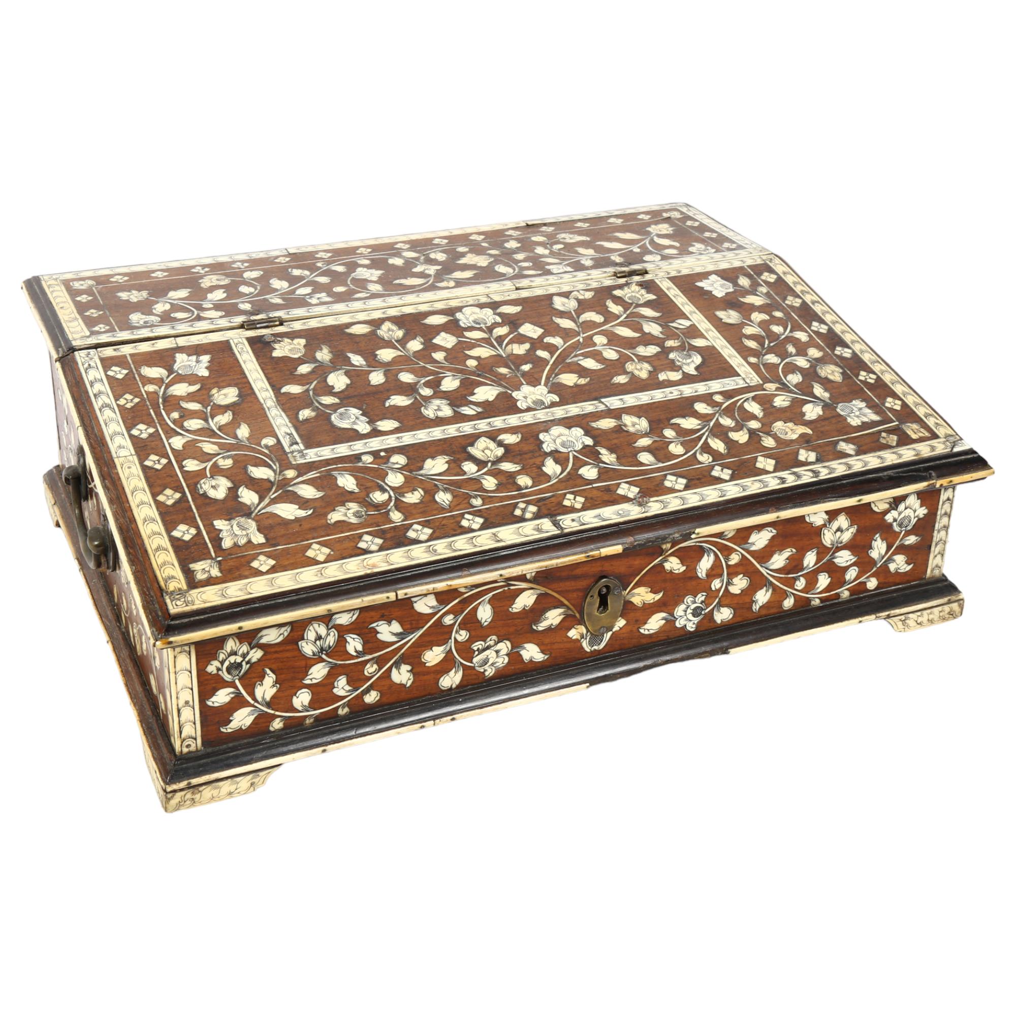A 19th century Indo-Portuguese writing box, teak and floral ivory inlaid, the rising top revealing