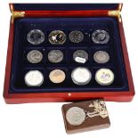 A case of commemorative coins, including 5 x Five Pound coins, and a pendant on chain