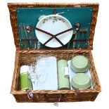 A wicker picnic hamper and contents