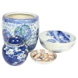 A Chinese blue and white bowl, a blue and white ginger jar and carver, prunus decorated, a
