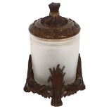 A Black Forest design biscuit barrel, with acanthus leaf carved lid and wheatsheaf knop, sitting